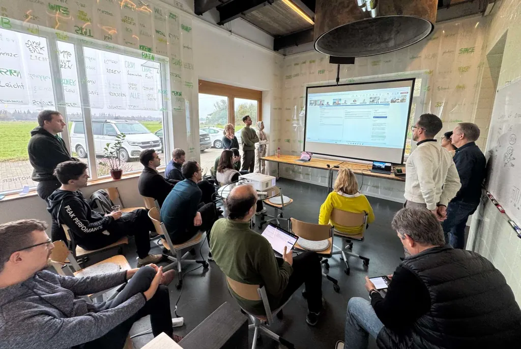Colleagues gathered for a presentation at an F24 hackathon.